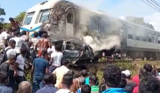 Car collides with train and catches fire!